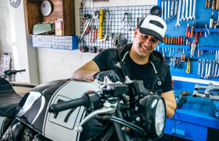 Motorcycle mechanic inspecting a bike at Motorbike Wreckers Brisbane